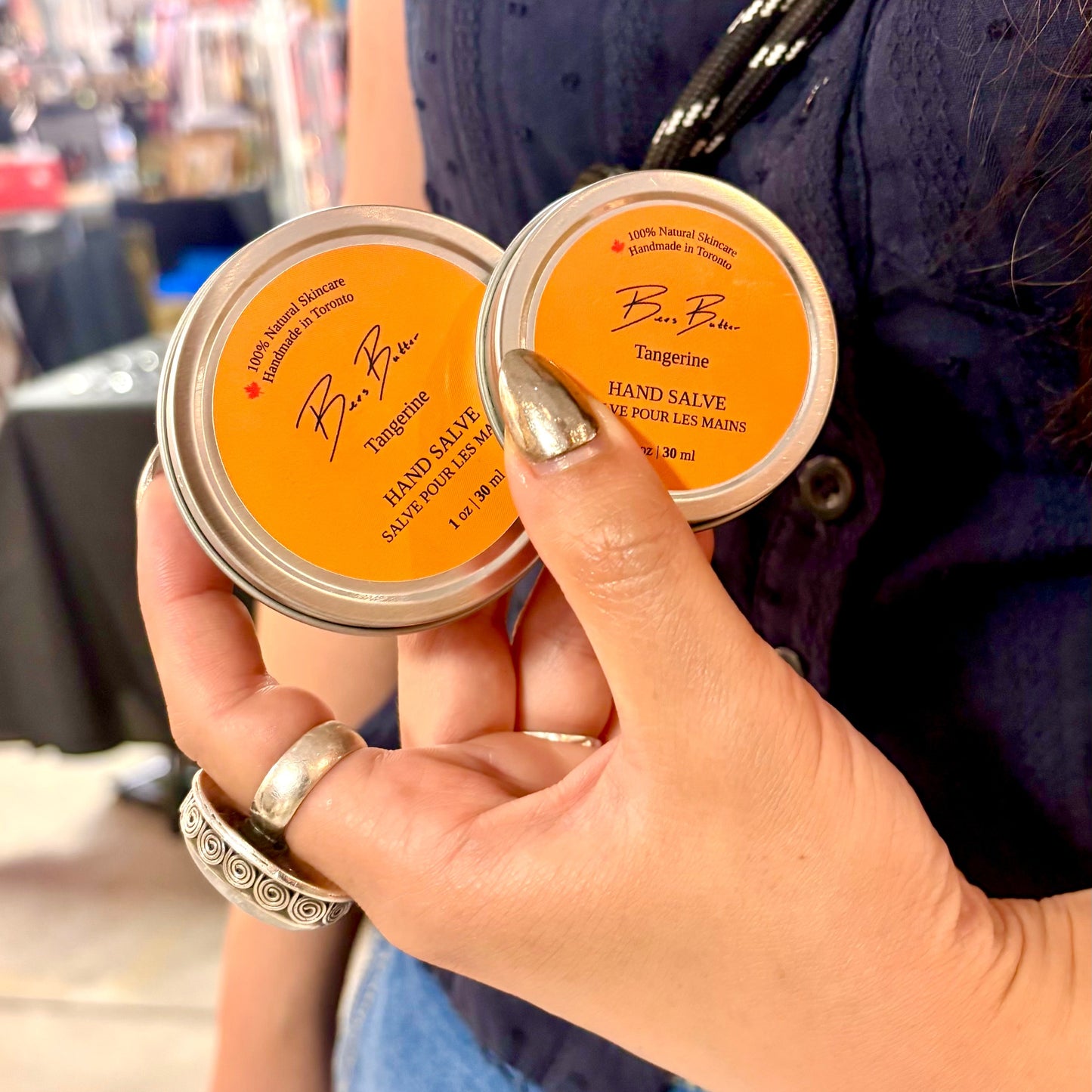 two different sizes of beeswax based hand salve