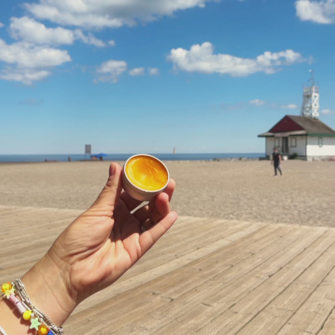 Hand application of bright orange hand salve